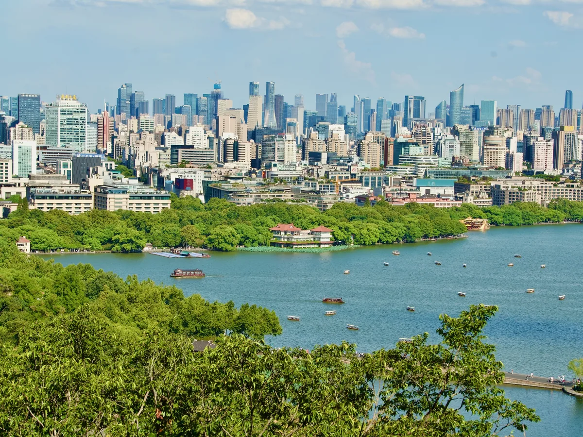 West Lake near the Broken Bridge with the Hangzhou city skyline beyond