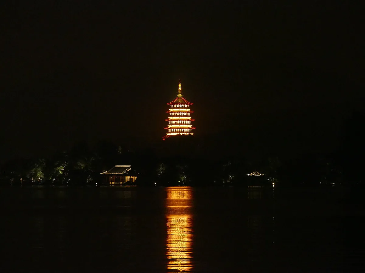 The Leifeng Pagoda illuminated at night on the shore of West Lake, Hangzhou